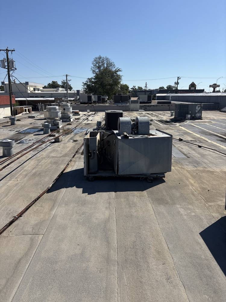 Commercial low-slope roof with rooftop HVAC units
