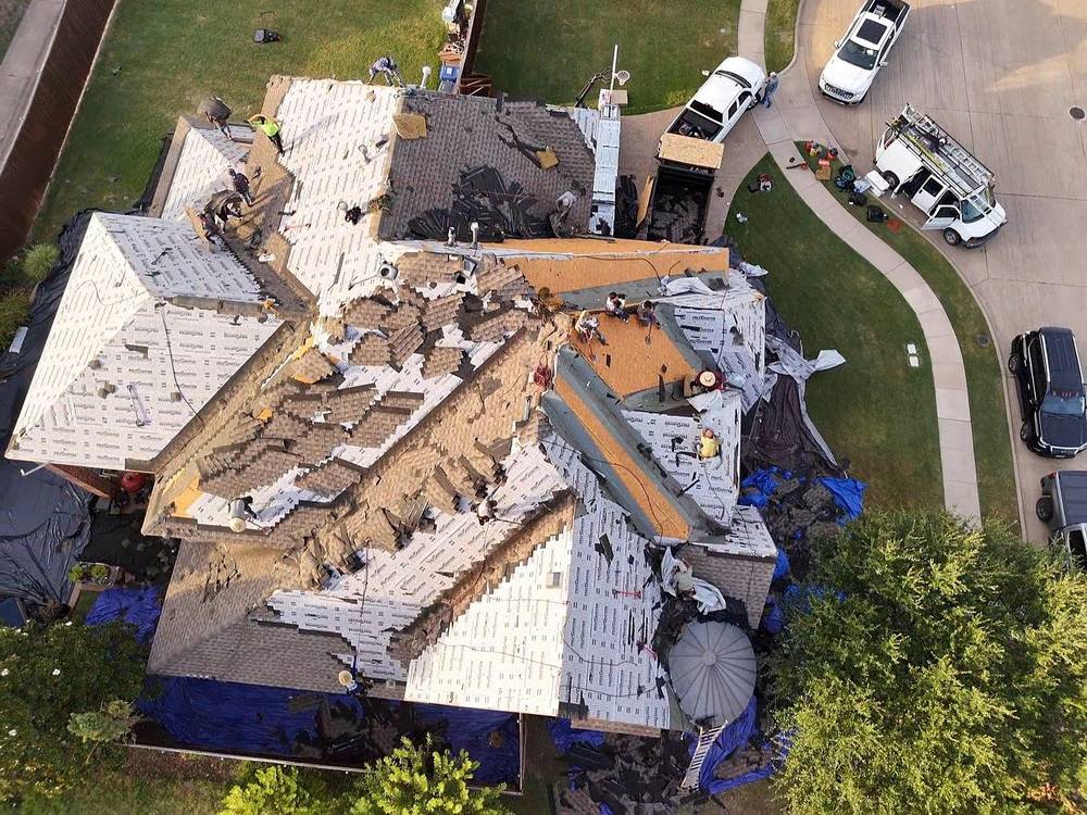 Top-down view of a full roof tear-off in progress