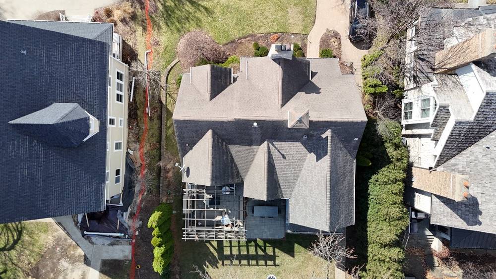Top-down drone view of a gray-shingle multi-gable roof in Hinsdale, IL