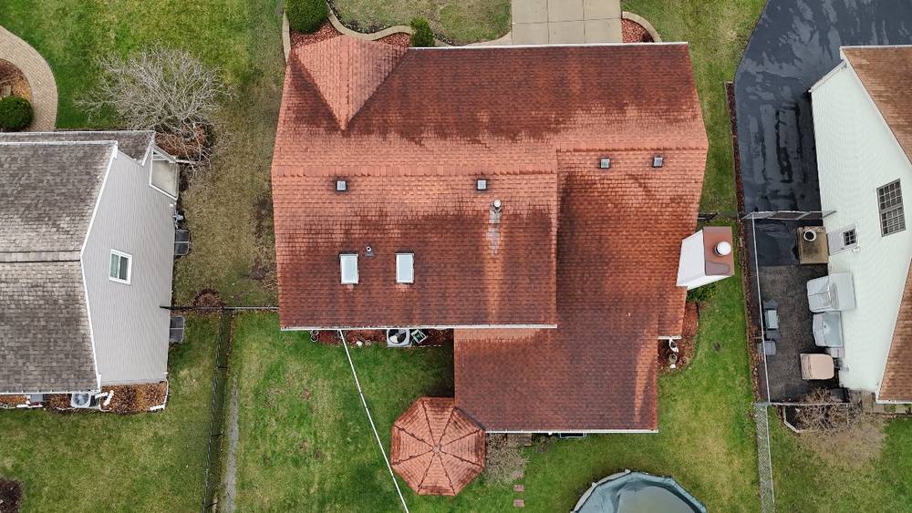 Top-down drone view of a large red terracotta-color shingle roof in Westmont, IL