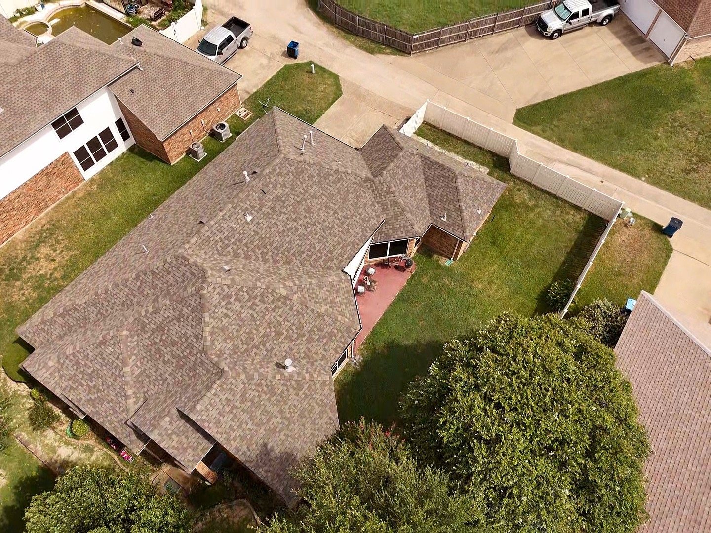 Completed new shingle roof on a suburban Texas home, aerial view