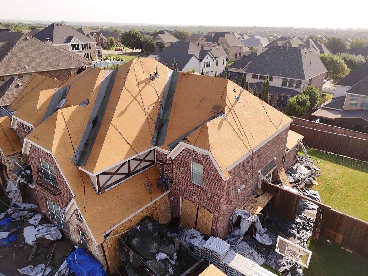 Completed roof replacement on a suburban Texas home, aerial view
