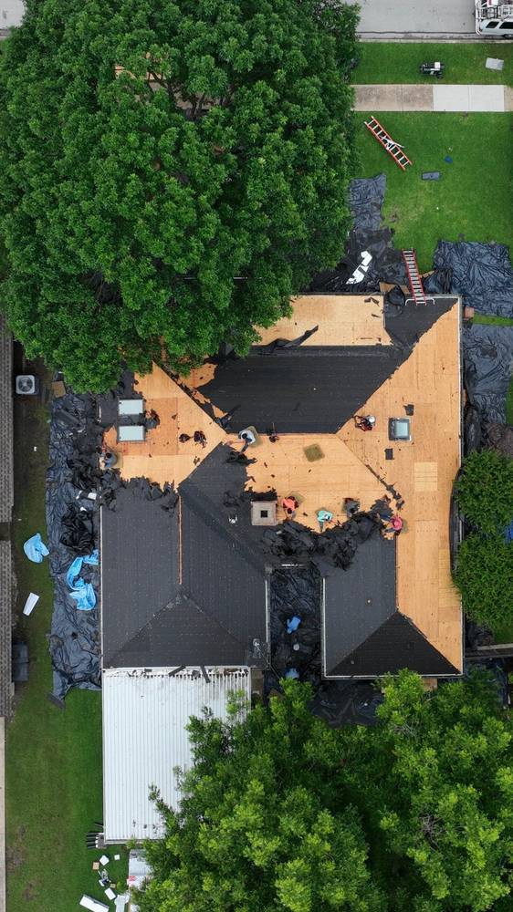Top-down view of new decking and felt during a roof replacement