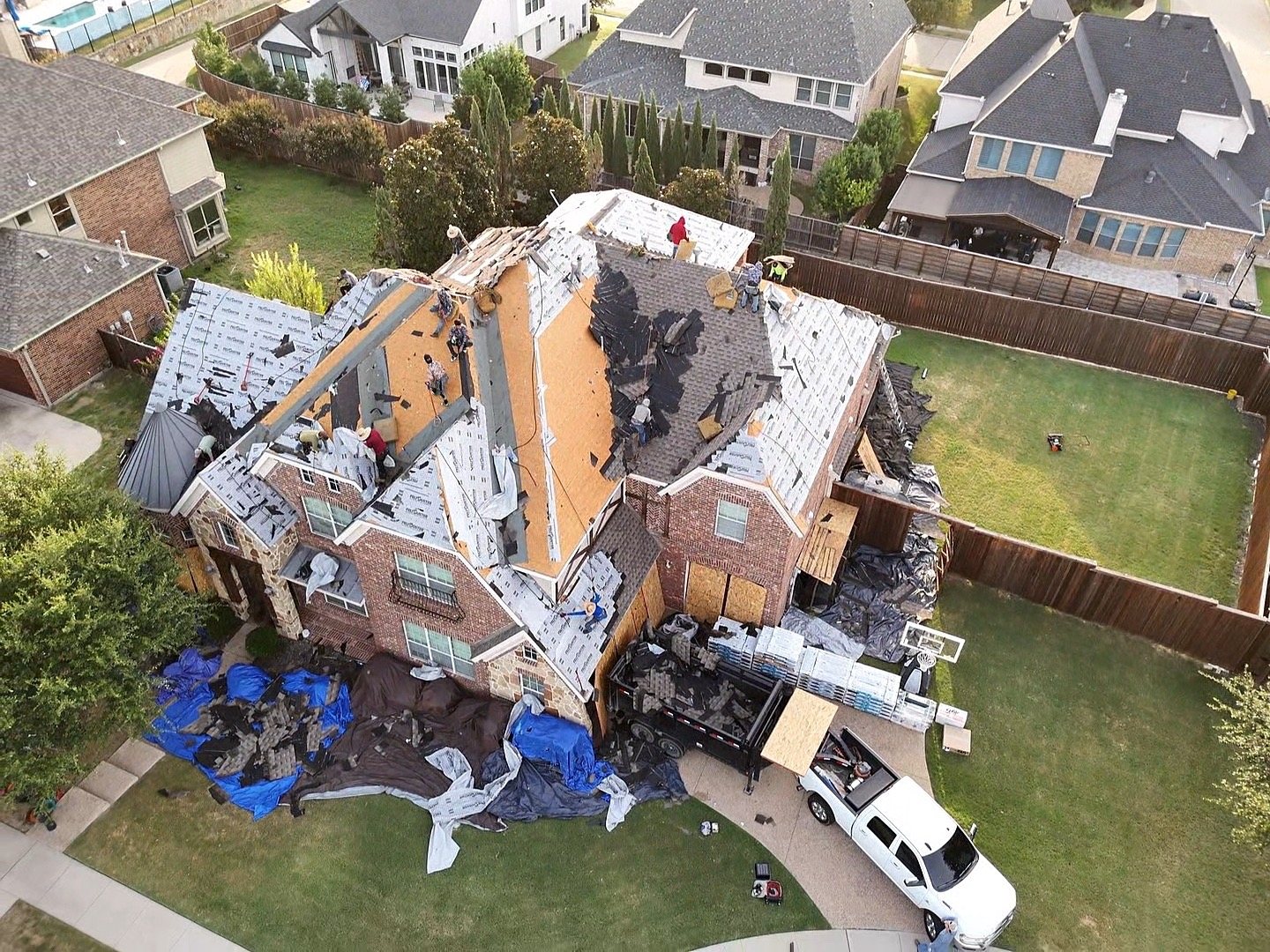 Hail-damaged roof restored — tear-off and new underlayment in progress