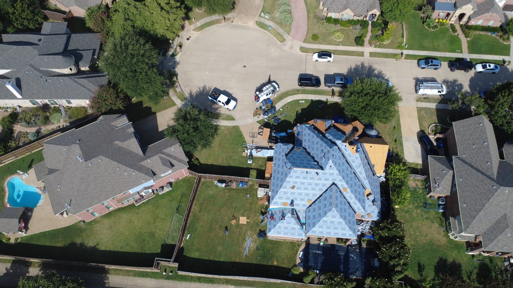 New roof installation with the crew laying synthetic underlayment