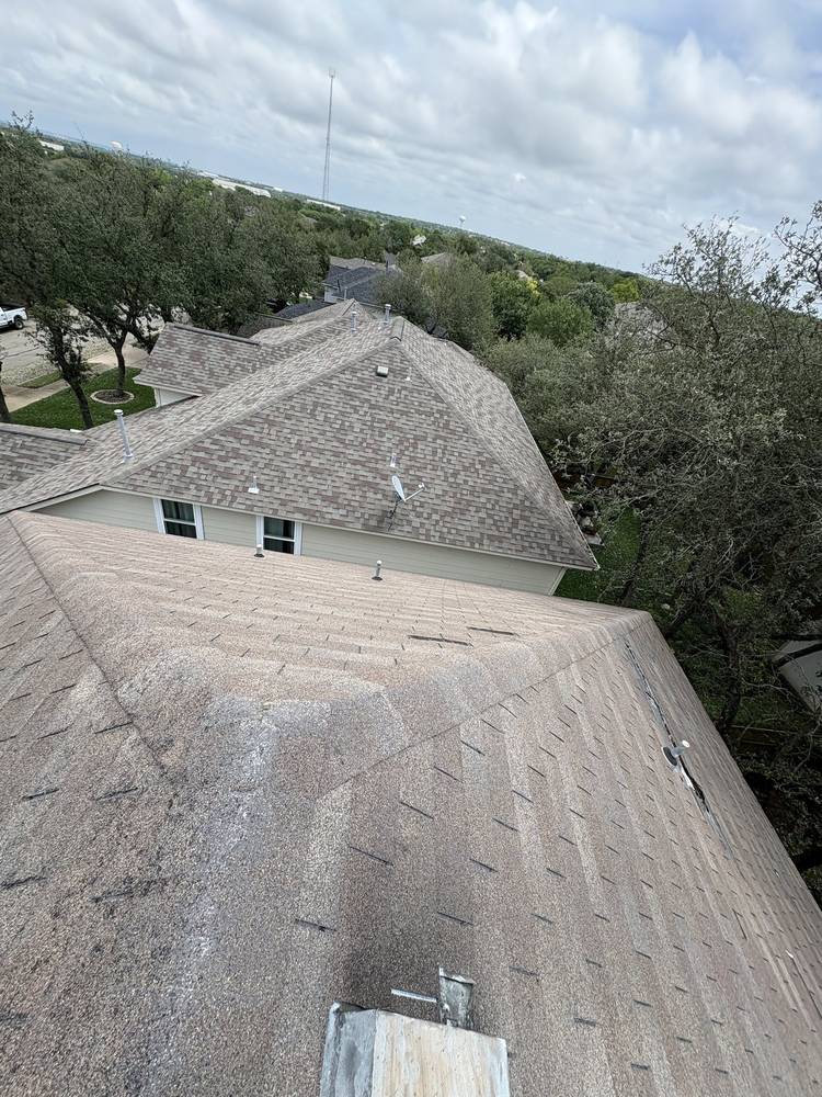 Storm-worn shingles with granule loss documented during a roof inspection